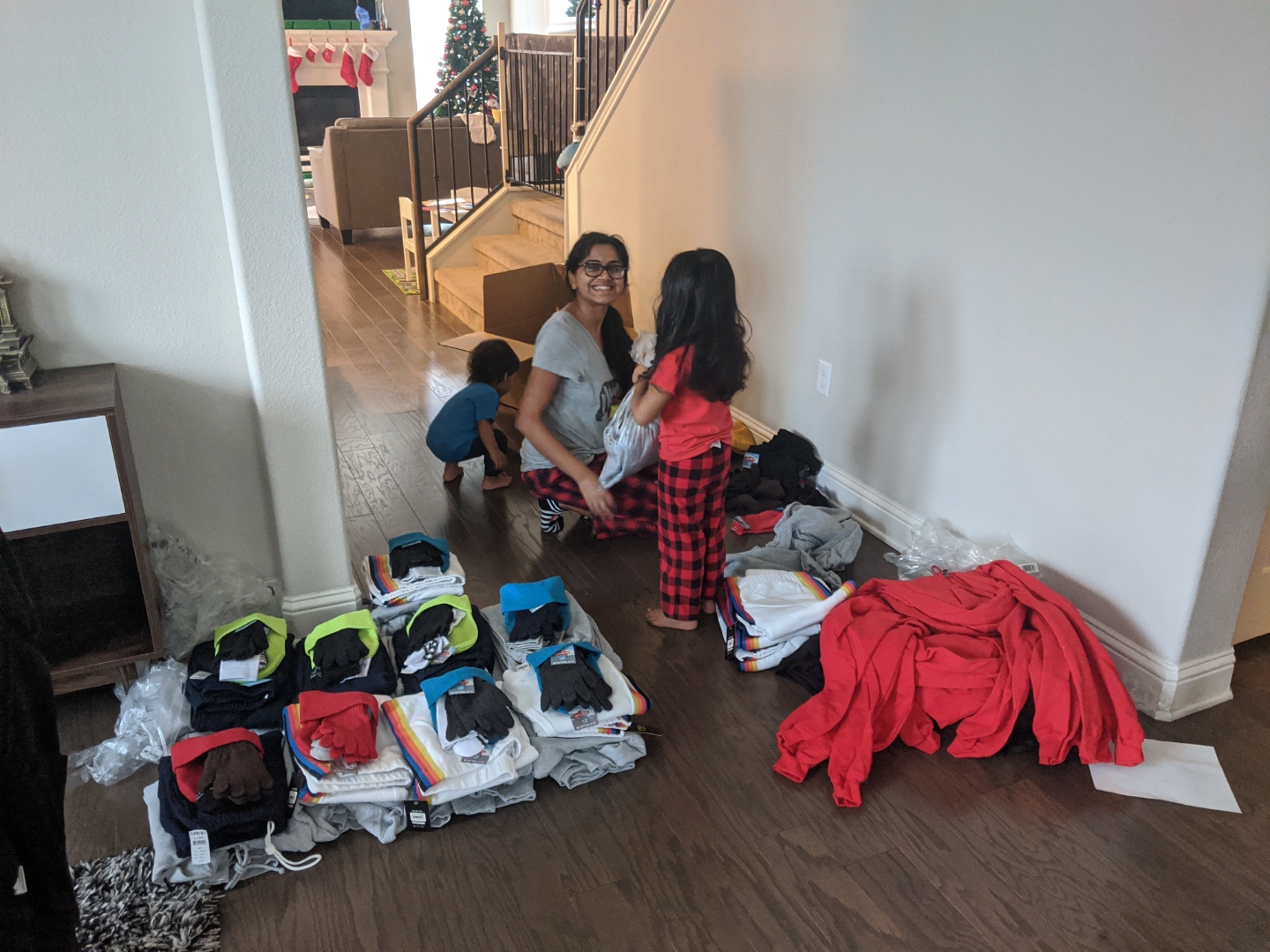 Purvi and the kids sorting clothes and supplies for care bundles